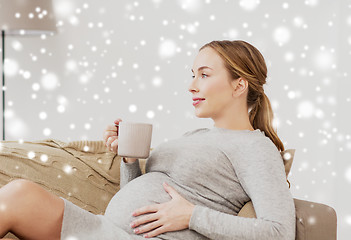 Image showing happy pregnant woman with cup drinking tea at home