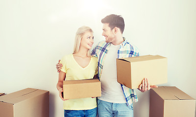 Image showing smiling couple with big boxes moving to new home