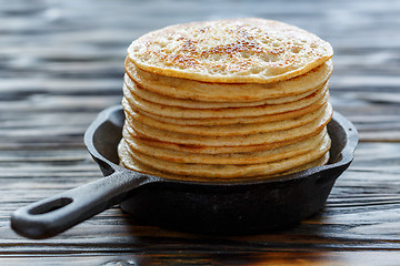 Image showing Stack of pancakes in a cast iron pan.