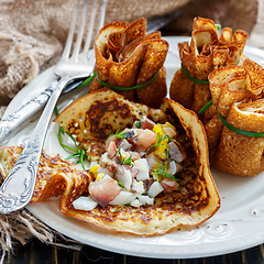 Image showing Pancake pouches filled with herring, eggs and greens.