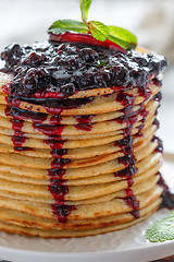Image showing Pancakes with berry sauce and mint close-up.