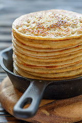 Image showing Cast iron pan with stack of fresh pancakes