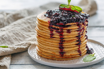 Image showing Stack of pancakes with berry sauce.