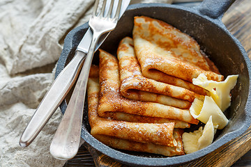 Image showing Crepes with butter sprinkled with powdered sugar.