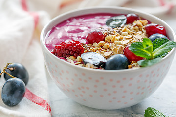 Image showing Healthy smoothie bowl with red beets and black grapes.