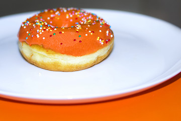 Image showing Appetizing donut decorated with orange glaze