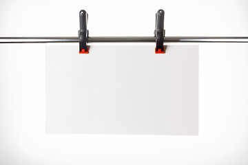 Image showing White plate hanging on pins