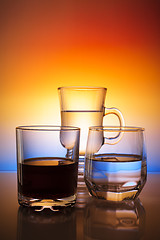 Image showing Glasses with beverages on beautiful gradient background