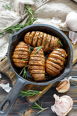 Image showing Frying pan with roasted potatoes and rosemary.