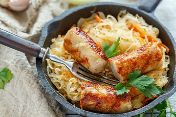 Image showing Steamed sauerkraut with grilled sausages.