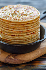 Image showing Cast iron pan with stack of fresh pancakes