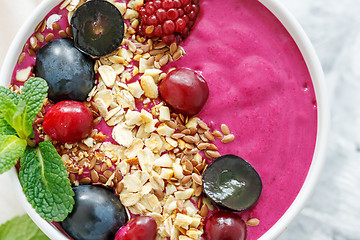 Image showing Red smoothie bowl with beets and black grapes.
