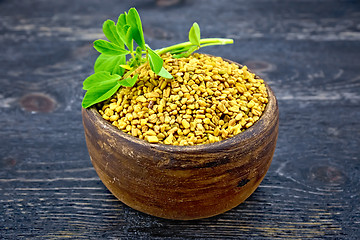 Image showing Fenugreek with leaf in clay bowl on board