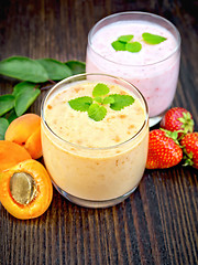 Image showing Milkshake apricot and strawberry on board