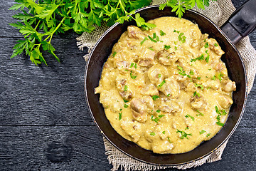 Image showing Meat stewed with cream in pan on board top