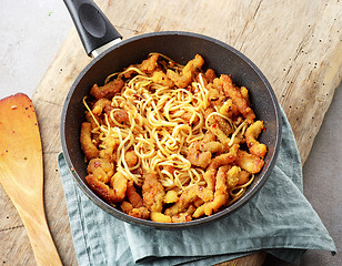 Image showing Asian noodles with fried meat on cooking pan