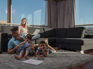 Image showing young couple spending time with kids at home