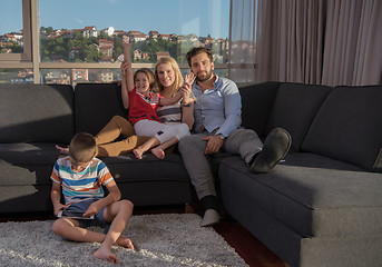 Image showing happy young couple spending time with kids at home