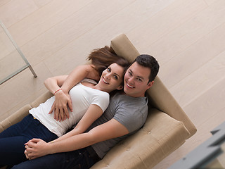 Image showing young handsome couple hugging on the sofa