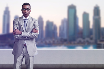 Image showing Young black businessman in front of the big city