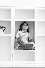 Image showing young boy posing on a shelf