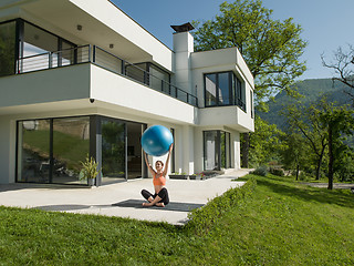 Image showing woman doing exercise with pilates ball