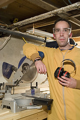 Image showing Young Man Holding His Ear Protection