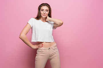 Image showing Pretty young sexy fashion sensual woman posing on pink background dressed in hipster style jeans