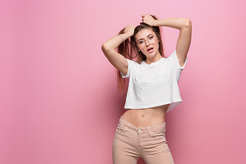 Image showing Pretty young sexy fashion sensual woman posing on pink background dressed in hipster style jeans
