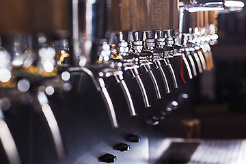 Image showing Beer taps in a pub