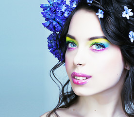 Image showing Beauty young woman with flowers and make up close up, real sprin