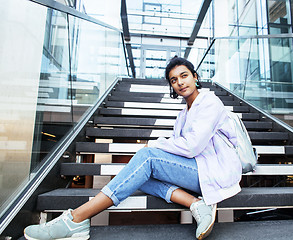 Image showing young cute indian girl at university building sitting on stairs 