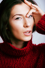 Image showing young pretty woman in sweater and scarf all over her face, lifes