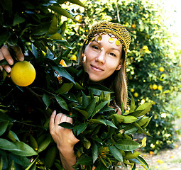 Image showing pretty islam woman in orange grove smiling