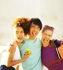 Image showing cute group of teenages at the building of university with books 