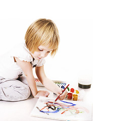 Image showing little cute blond girl painting isolated