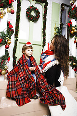 Image showing happy smiling family on Christmas at house with gifts, young mot