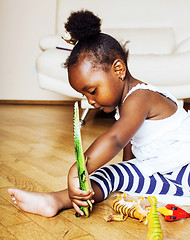 Image showing little cute african american girl playing with animal toys at ho