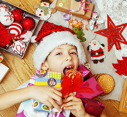 Image showing little cute boy with Christmas gifts at home. close up emotional