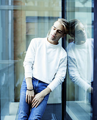 Image showing young modern hipster guy at new building university blond fashion hairstyle having fun, lifestyle people concept 
