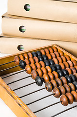 Image showing Old abacus and folders with documents, close-up isolated on whit