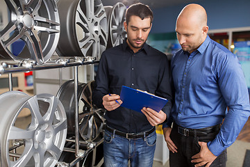Image showing customer and salesman at car service or auto store