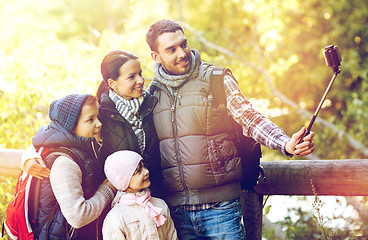 Image showing family with backpacks taking selfie and hiking