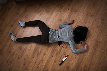 Image showing dead woman body lying on floor at crime scene