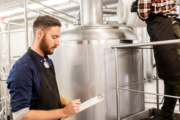 Image showing men working at craft brewery or beer plant