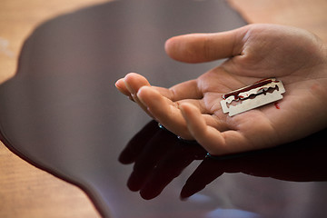 Image showing dead woman hand in blood on floor at crime scene