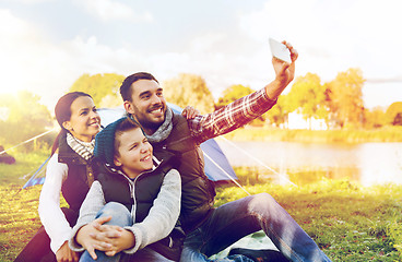 Image showing family with smartphone taking selfie at campsite