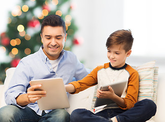 Image showing happy father and son with tablet pc at christmas