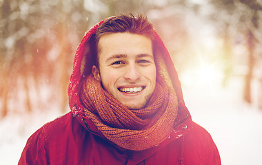 Image showing happy man in winter jacket with hood outdoors