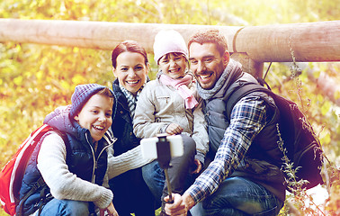 Image showing family with backpacks taking selfie and hiking